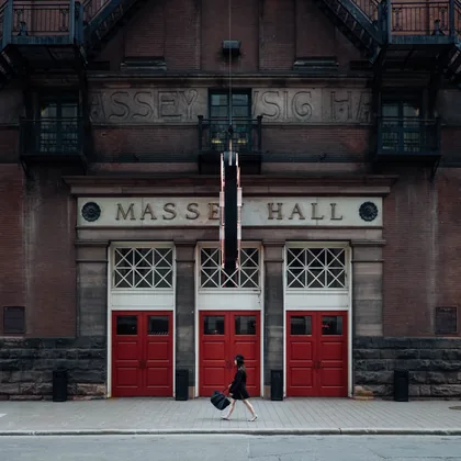 Woman Walking Past Three Red Doors