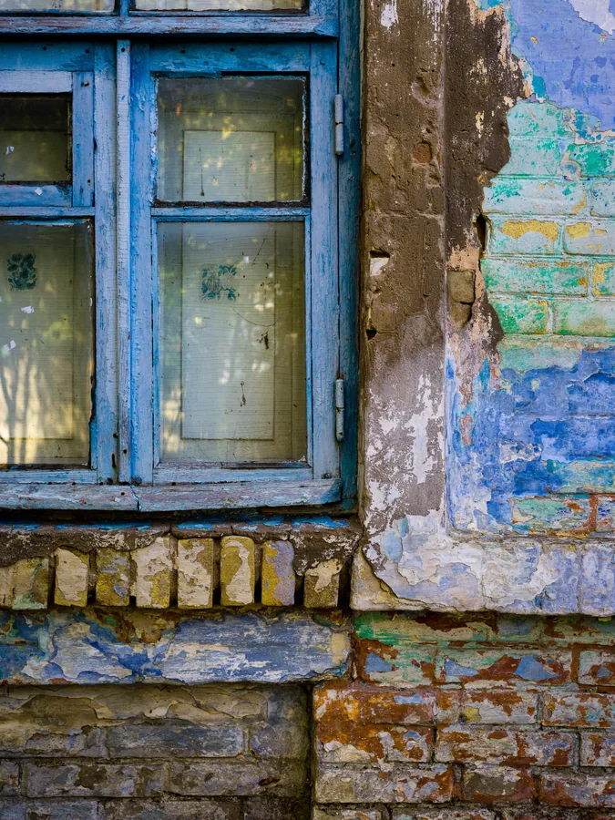 Peeling Blue Window and Painted Brick