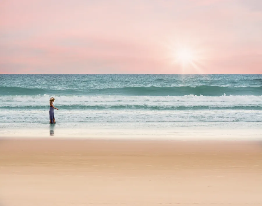 Girl Wading in Surf at Sunset