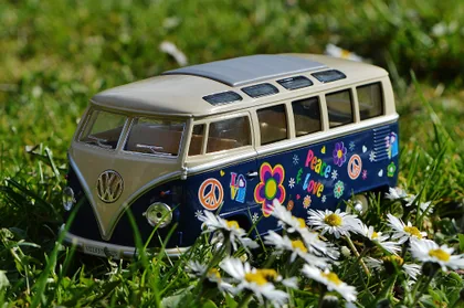 A Toy Volkswagen Bus Among Daisies