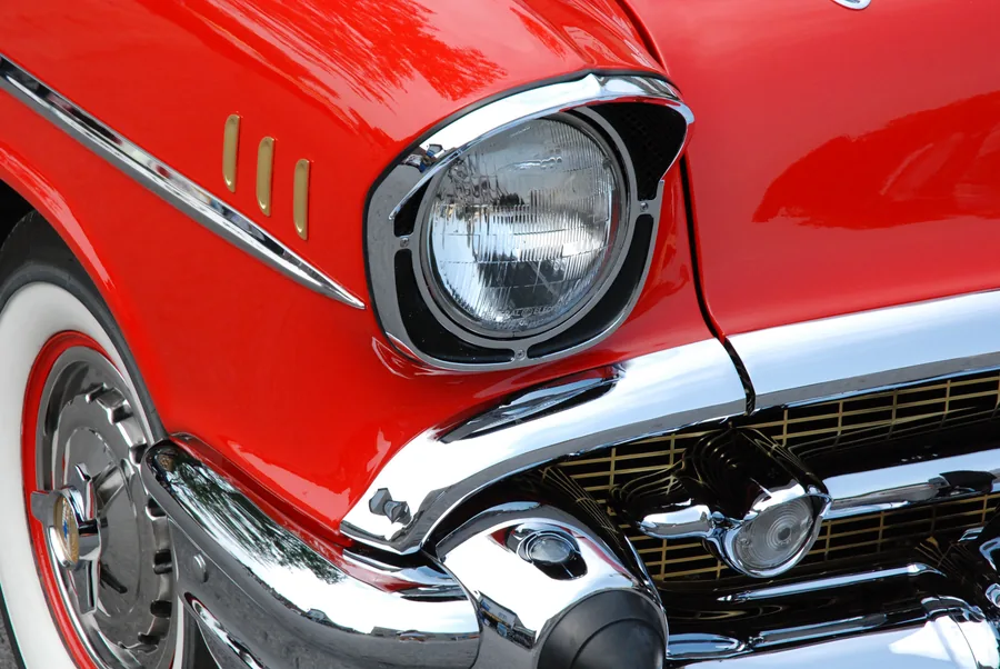 Chrome Headlight of a Red Classic Car