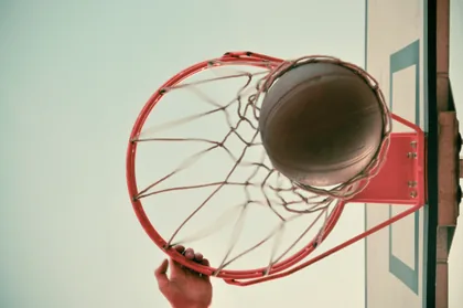 A Basketball Dropping Through the Hoop