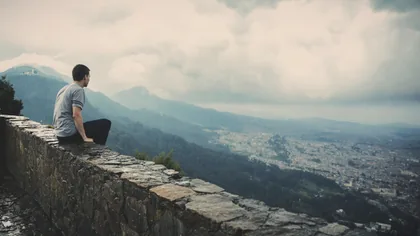 Man on a Wall Above the City
