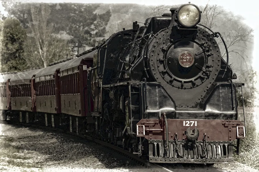 A Steam Locomotive Pulling Maroon Carriages
