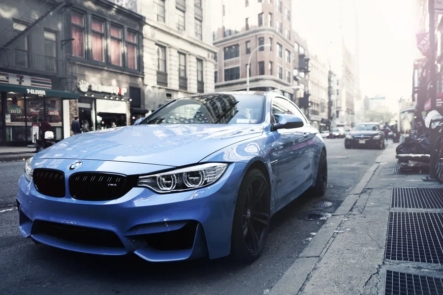 A Blue BMW Coupe on a City Street
