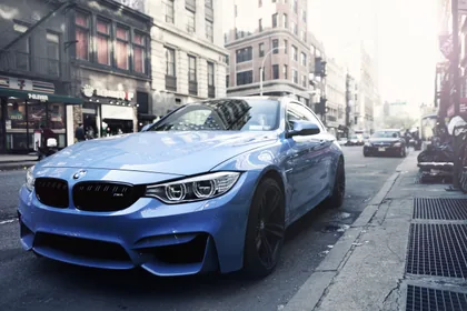 A Blue BMW Coupe on a City Street