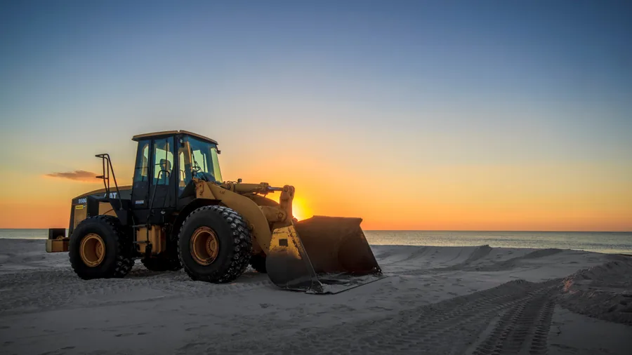 A Wheel Loader on the Beach at Sunset