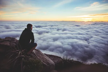 Man Sitting Above a Cloud Sea