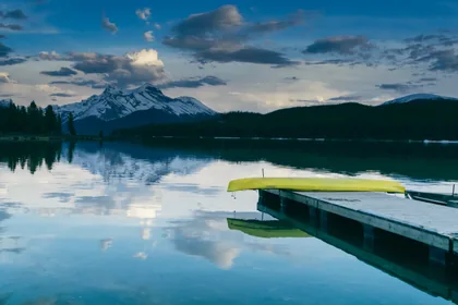 Yellow Canoe on a Lake Jetty