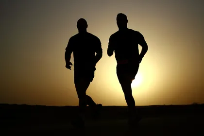 Two Runners Against the Sunset